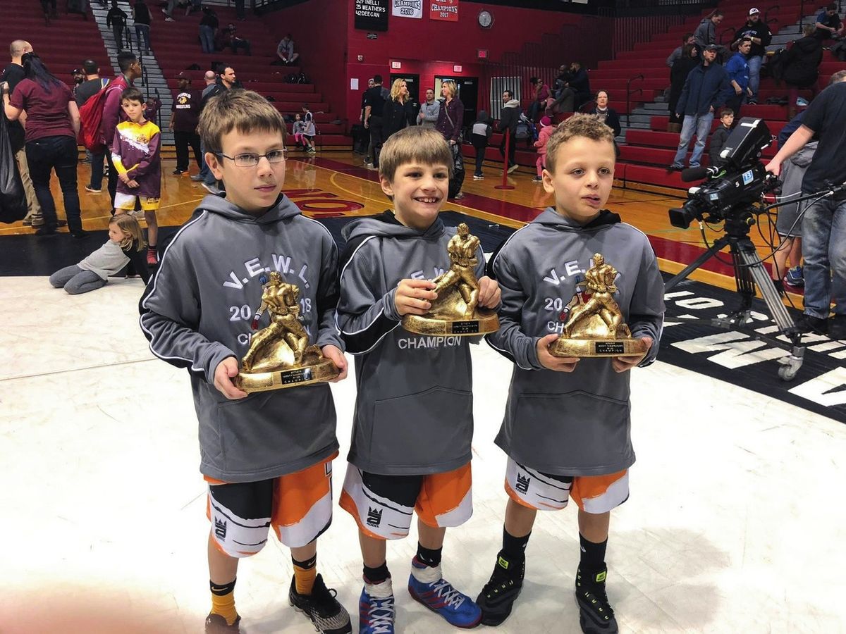 Three Northampton youth wrestlers hold VEWL champion trophies